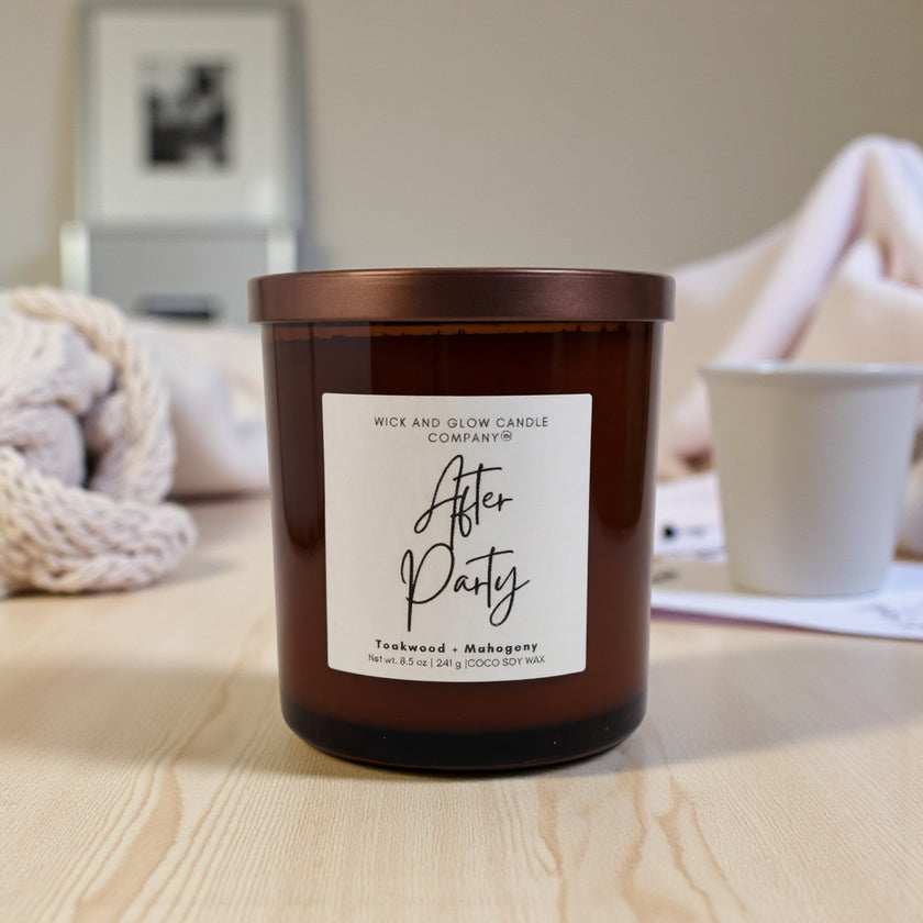 Candle with 'After Party' label on a wooden surface, blurred background