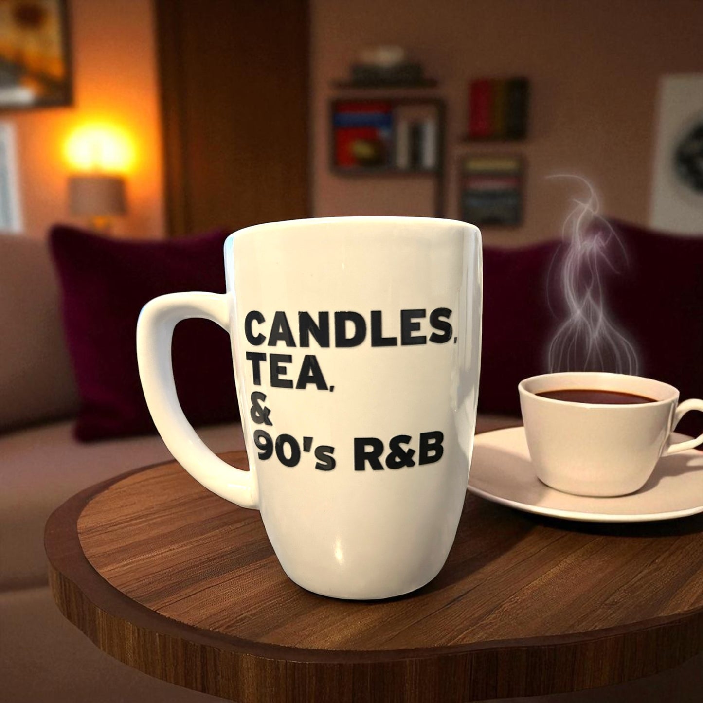 White mug with text 'CANDLES, TEA, & 90's R&B' on a wooden table with a cup of coffee.