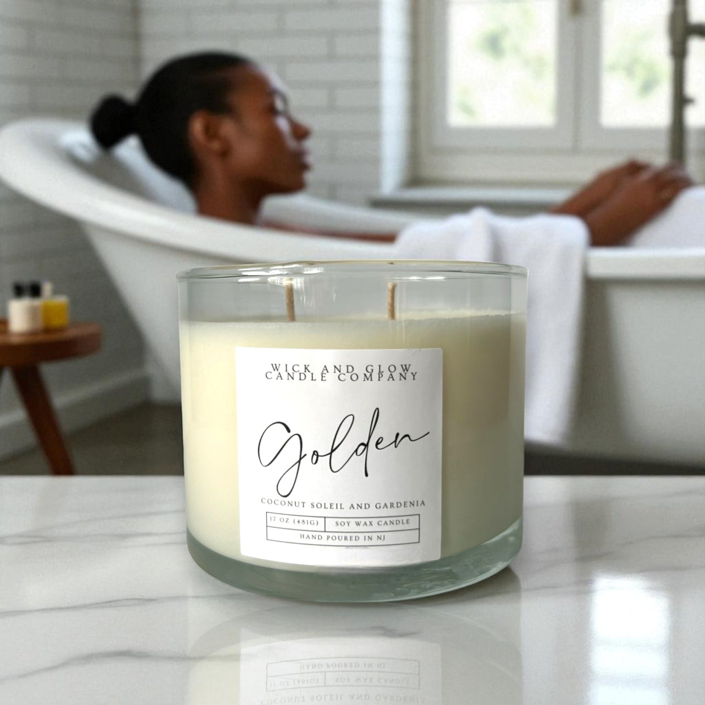 Candle with 'Wick and Glow Candle Company' label in a bathroom setting