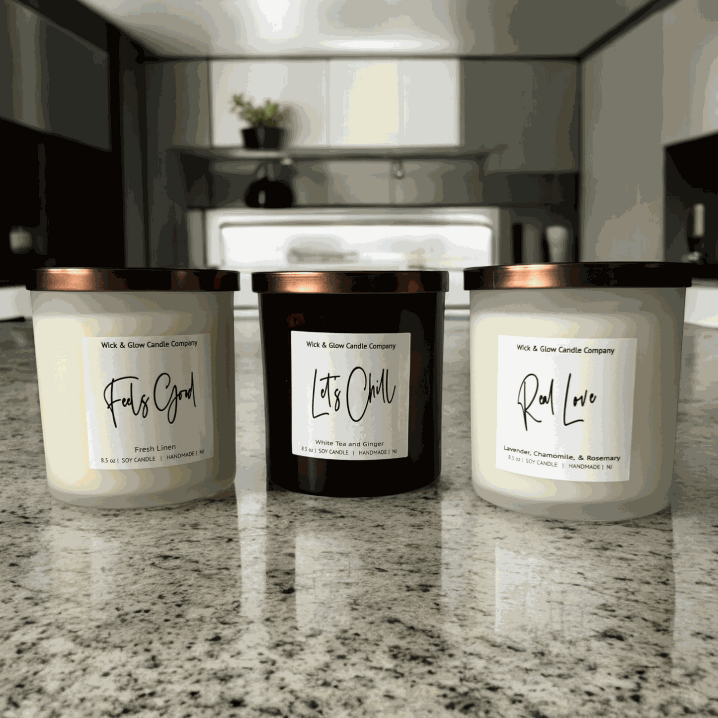 Three Wick and Glow candles in white and amber jars with bronze lids. Lavender candle, fresh cotton candle, white tea and ginger candle. Glow candles.