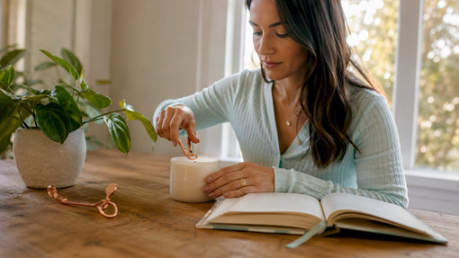 Woman trimming wick of non-toxic candle
