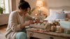 Woman assembling affordable candle gift box