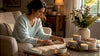 Woman arranging candle gift checklist at table