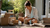 Woman preparing candle gifts at home