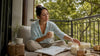 Woman reading candle info near natural candles