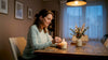 Woman lighting soy candle in cozy living room