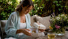 Woman opening fragrance gift with warm sunlight