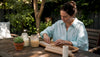Woman arranging eco-friendly candle wicks at home table