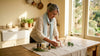 Woman arranging home fragrance items in living room