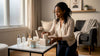 Woman arranging luxury home fragrance gifts indoors