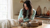 Woman selecting scented candle gift thoughtfully