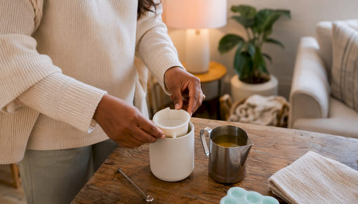 Hands placing silicone insert into candle jar