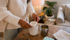 Hands placing silicone insert into candle jar