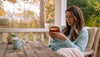 Woman holding candle in warm cozy living room