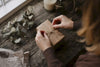 Hands tying twine bow on handmade gift