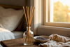 Reed diffuser with reeds on wooden side table