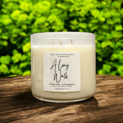 17 oz soy candle in clear glass vessel labeled 'A Long Walk', featuring green tea and lemongrass scent.