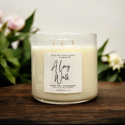 17 oz soy candle in clear glass vessel labeled 'A Long Walk', featuring green tea and lemongrass scent.