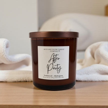 Candle with a label on a wooden surface, with a blurred background