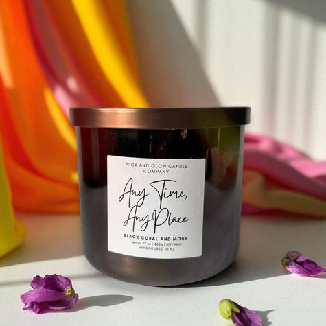 Luxury soy wax candle with a label on a surface with flowers and colorful background