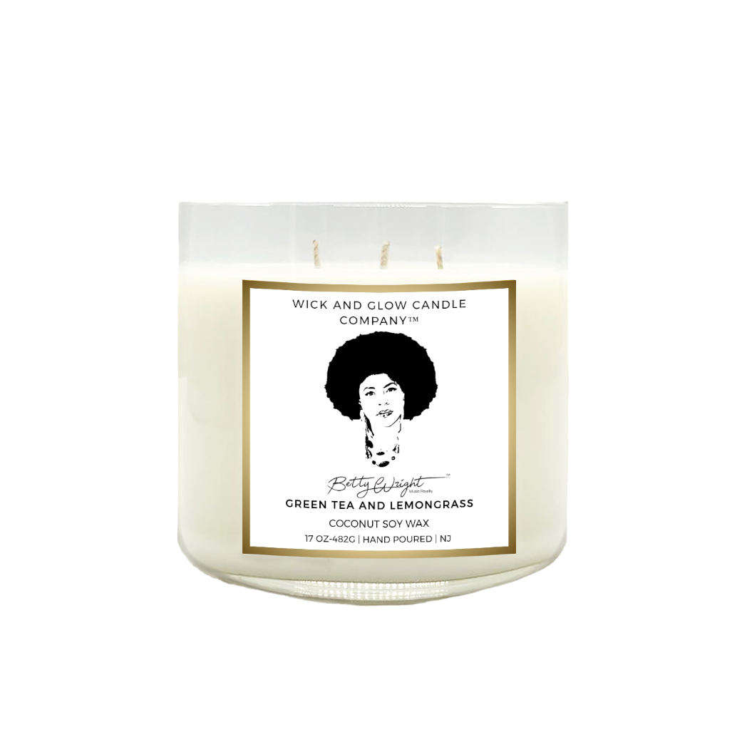 clear 3 wick candle with a white and gold label that reads green tea and lemongrass