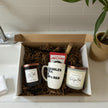 Gift box with candles and a mug on a kitchen counter