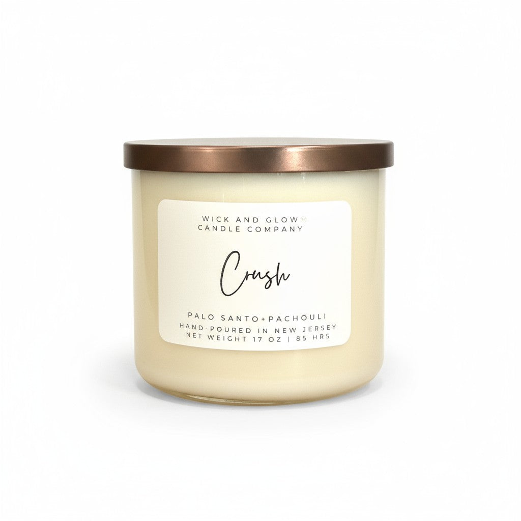 Palo Santo and Patchouli white candle with a bronze lid by Wick and Glow Candle Company