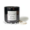 A black glass jar candle with a white label reading 'Diamonds & Pearls' by Wick and Glow Candle Company, styled with faux pearls and clear gemstone props on a white background.