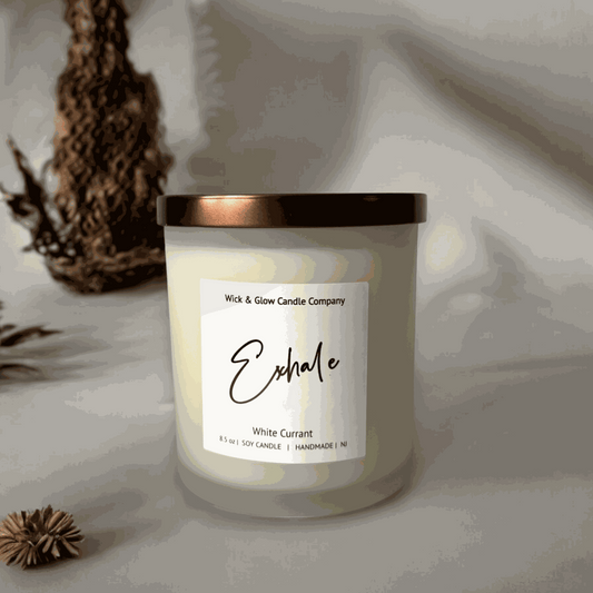 White currant soy wax candle in a frosted white glass jar with a bronze lid on a white table with on a white background from Wick and Glow Candle Company