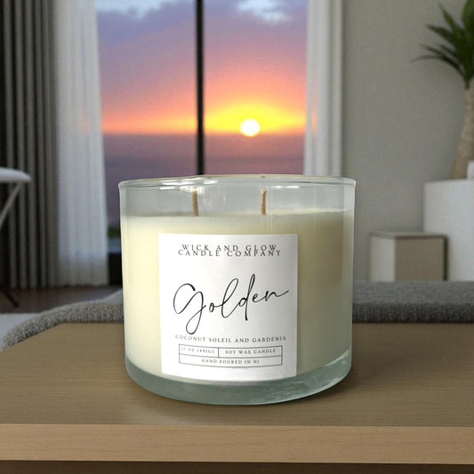 Candle with a label on a surface with a sunset view in the background