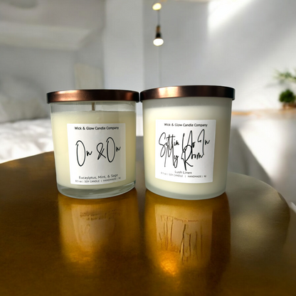 Pair of soy candles in frosted white glass jars with bronze lids, labeled 'Self Care Duo'